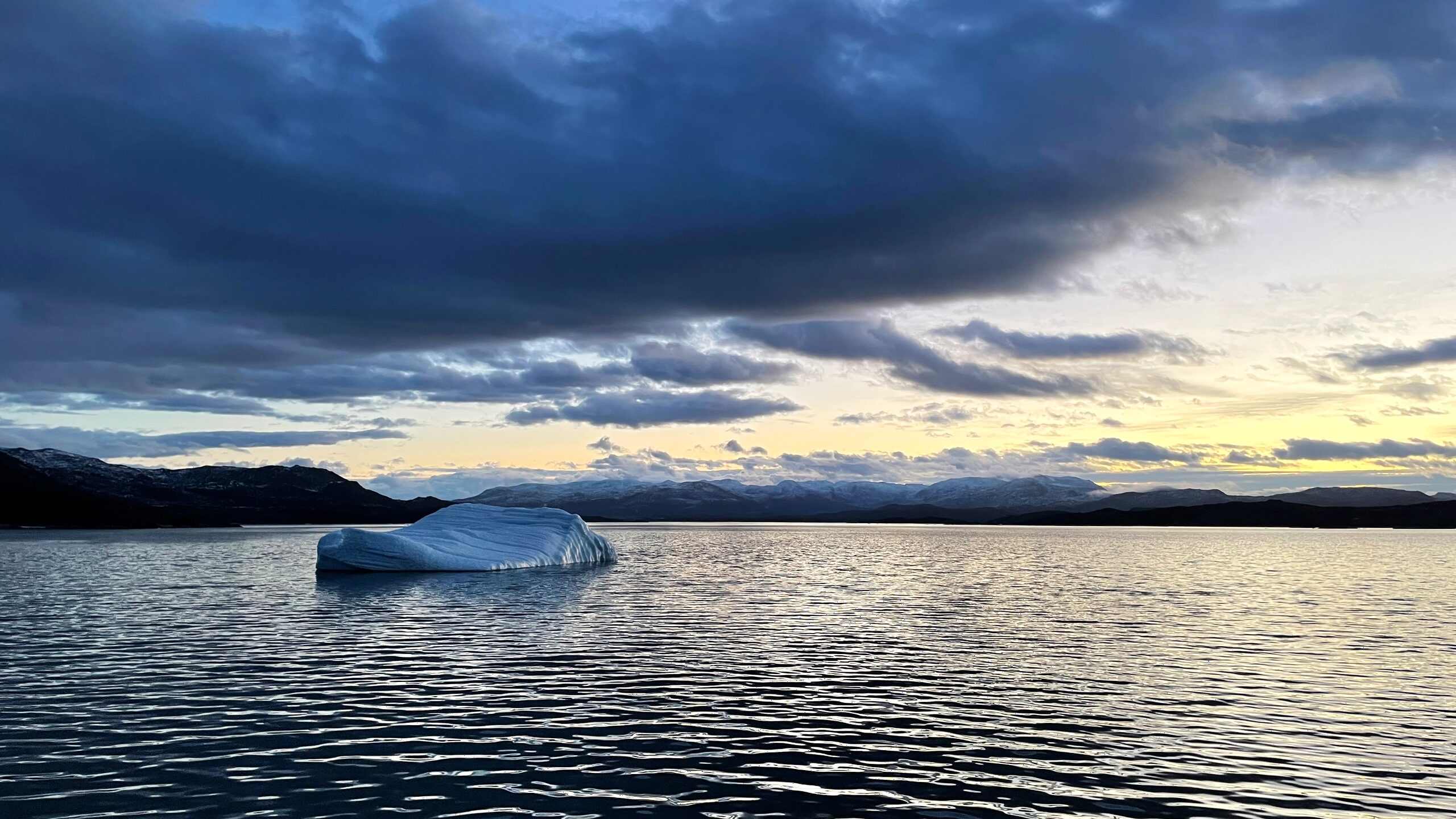 Iceberg at dusk on a Greenland fjord